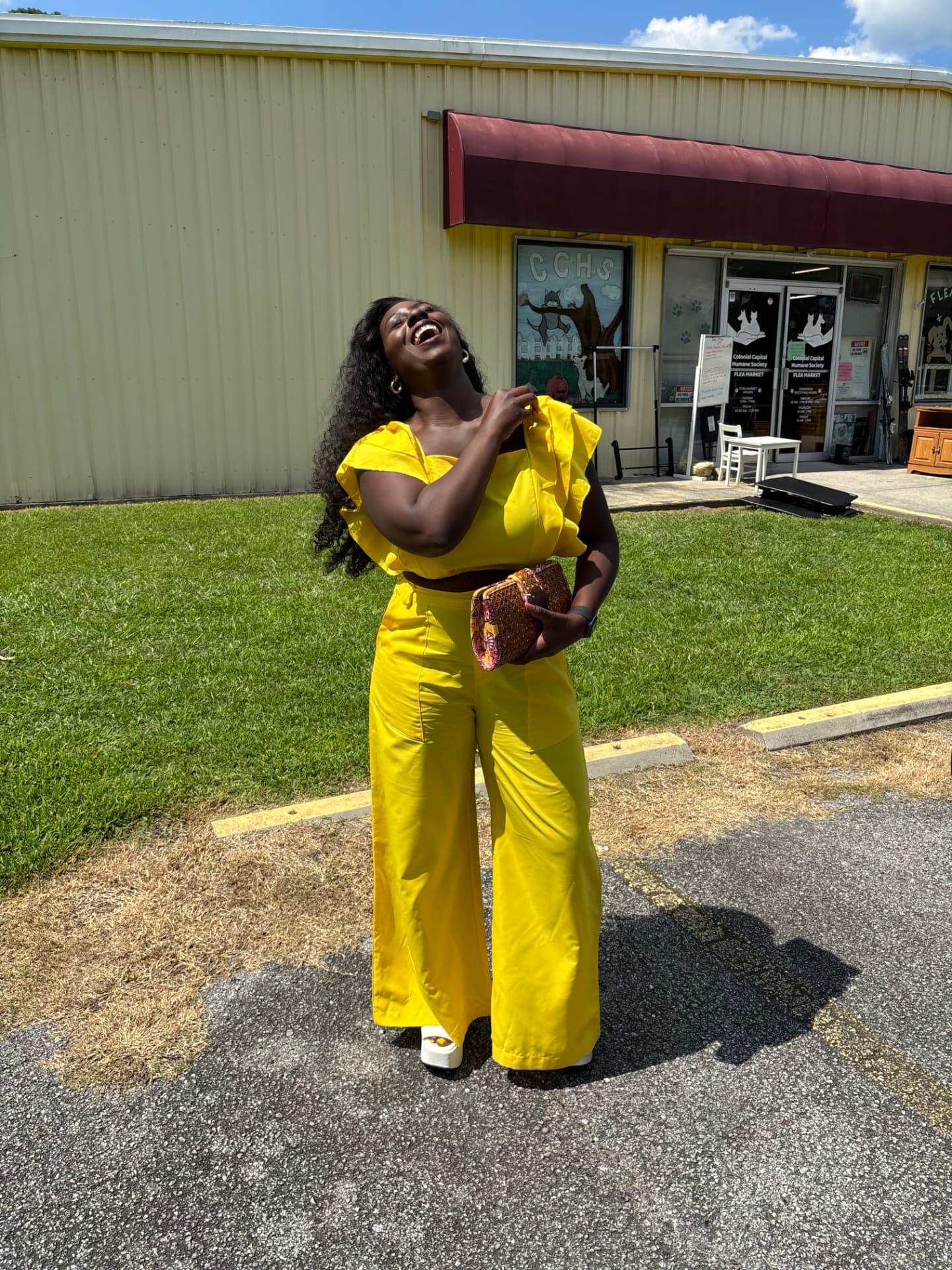 Moriah Davis laughing in a yellow ruffled top and wide-leg pants